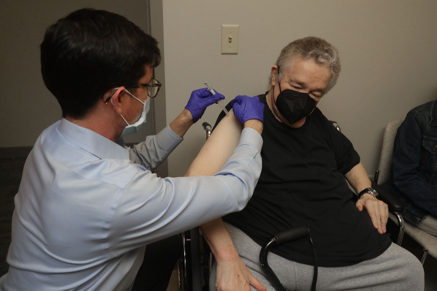 Dr. Ben Zwierzchowski administers the flu shot to Thomas Allingham